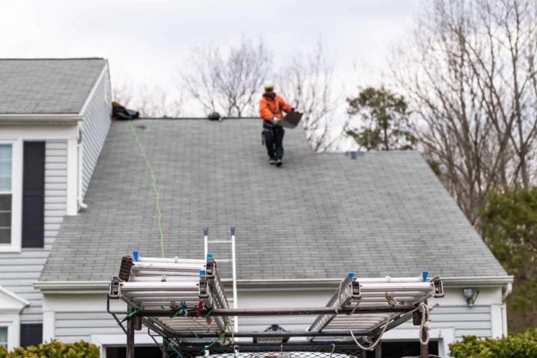 Man on the top of roof after fixing it