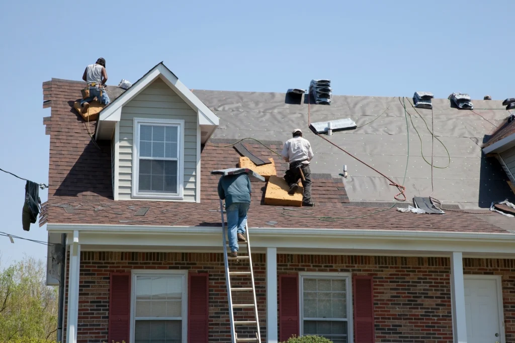 workers replacing the house roof