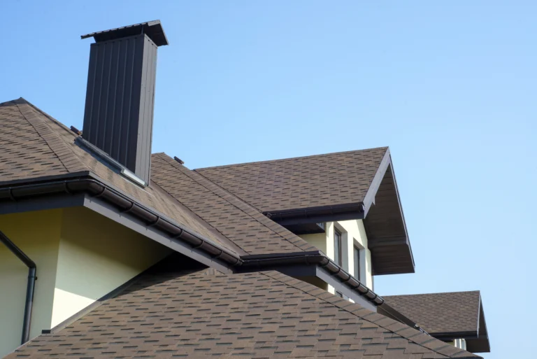 dark brown asphalt shingle roof and chimney