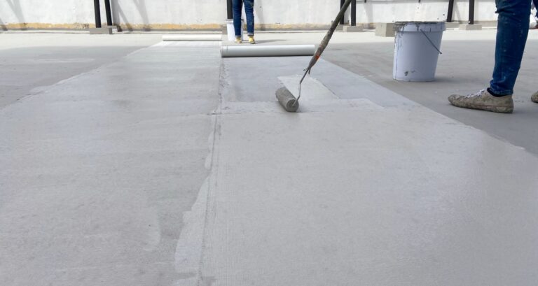roofers applying roof coating, rubber roof cost