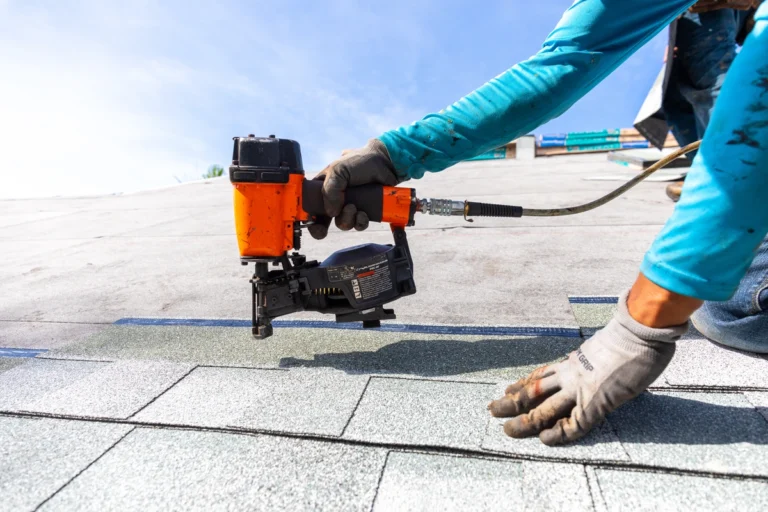 roof tech using power tools to install roof shingles
