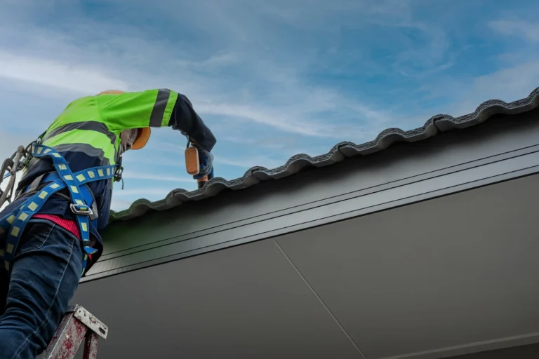 roof tech using power tools to install shingles on roof
