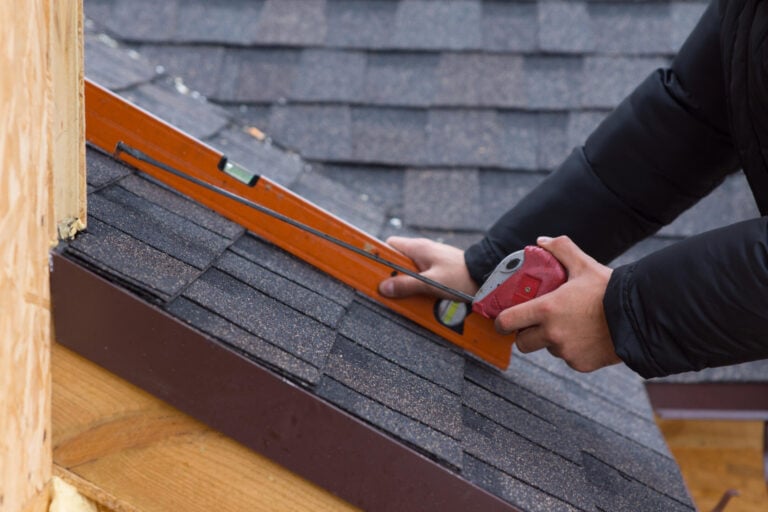 how to calculate roof pitch-close up of a roof tech using hand tools to measure roof