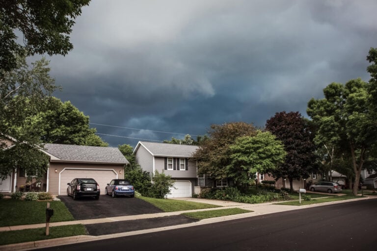 storm damage roof insurance claim-suburban houses with inclement weather looming