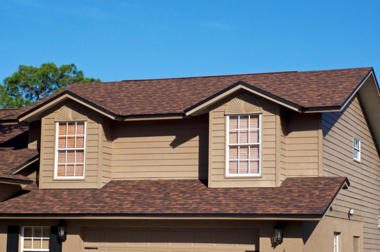 roof rejuvenation-distant view of brown architectural shingles on a brown sided house