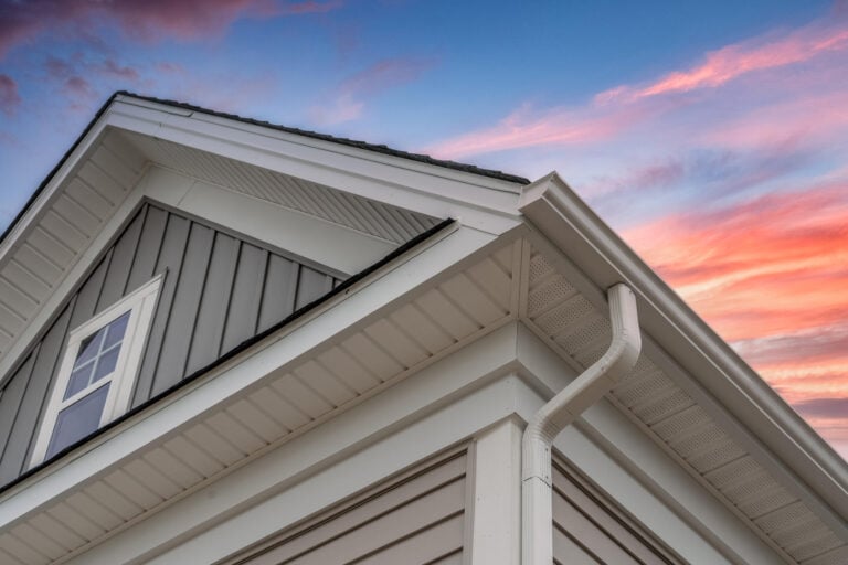 gray sided house with white fascia, soffit, and frieze boards