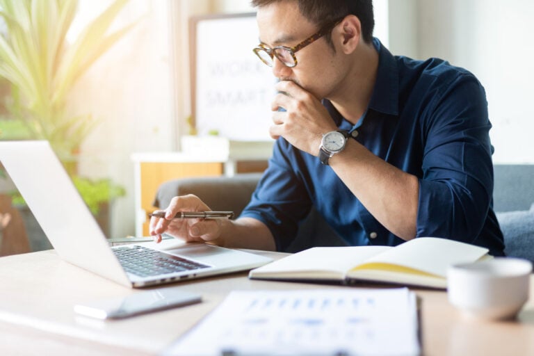 instant roof quote-man comparing prices for roof replacement on his laptop