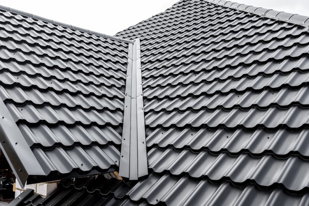 Construction of the roof of the house. Metal tiles.